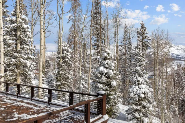 a living room with furniture and large windows