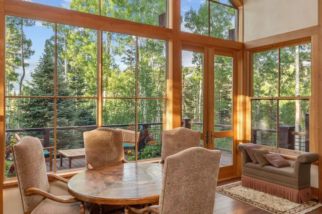 a dining room with furniture a flat screen tv and balcony