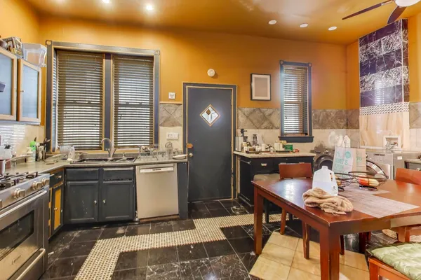 a kitchen with a sink appliances and cabinets