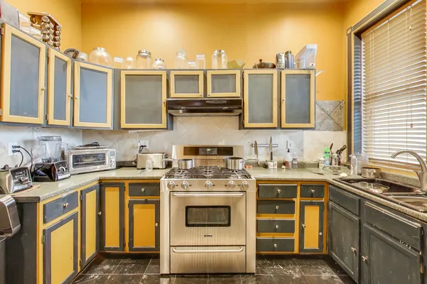 a kitchen with a stove top oven sink and cabinets