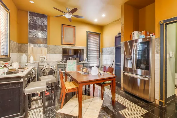 a kitchen with a refrigerator a sink and cabinets