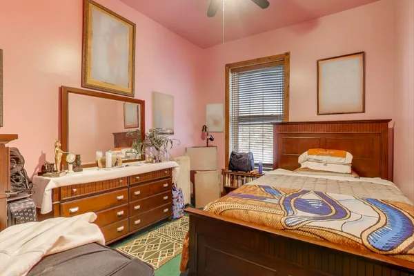 a bedroom with two beds and painting on the wall