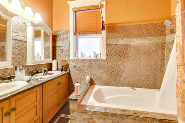 a bathroom with a tub sink and mirror