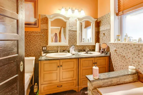 a bathroom with a granite countertop sink and a mirror