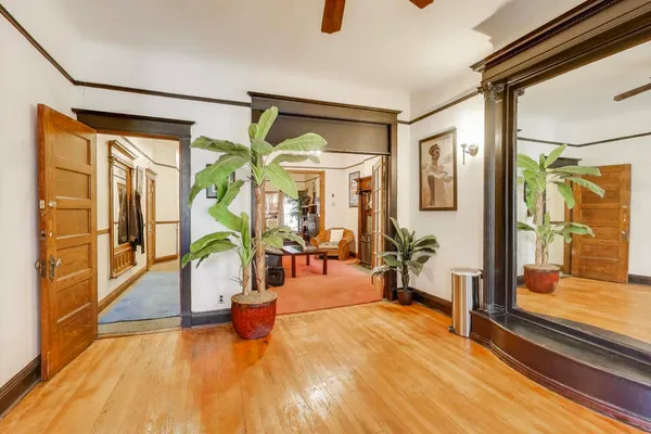 a dining room with furniture and wooden floor