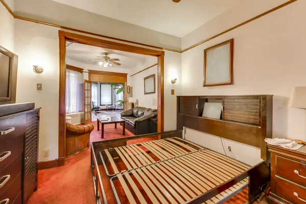 a living room with furniture a rug and a toilet