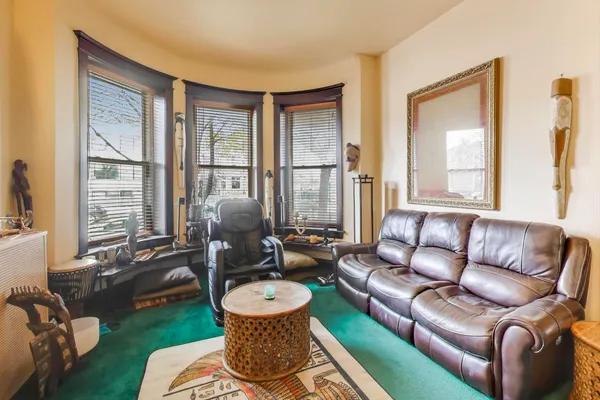 a living room with furniture and a large window