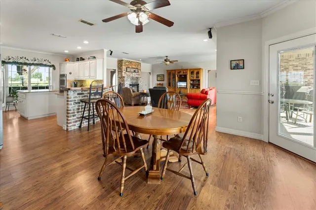 a dining room with furniture a window and wooden floor