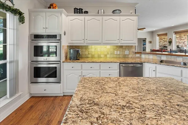 a spacious bedroom with a bed and glass door