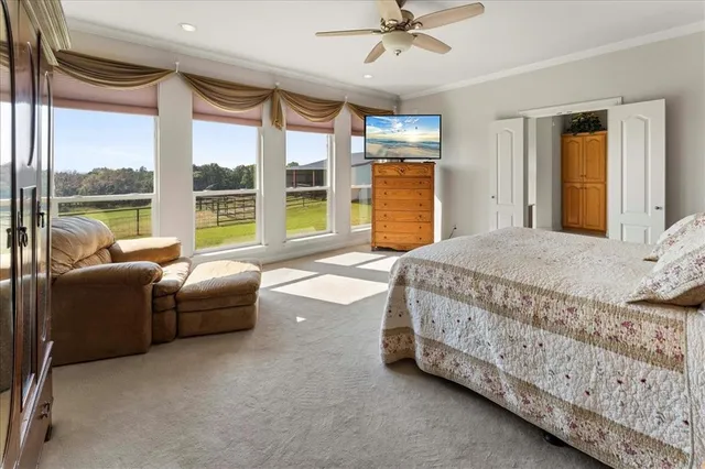 a spacious bedroom with a bed and a chandelier