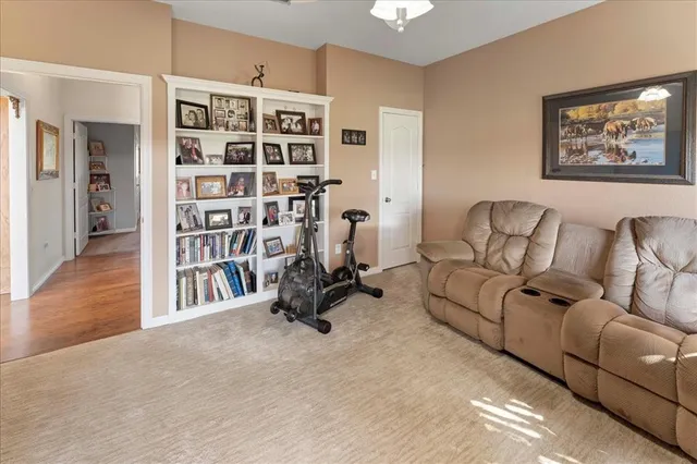 a spacious bathroom with a double vanity sink a mirror a toilet and a window