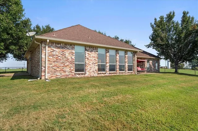 a view of a house with a yard and tree