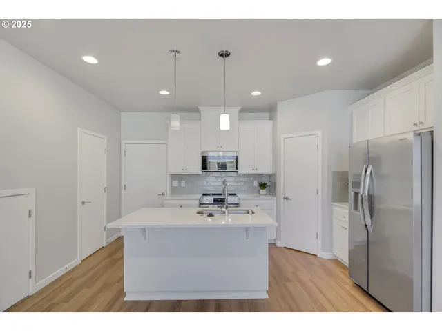 a kitchen with refrigerator cabinets and microwave