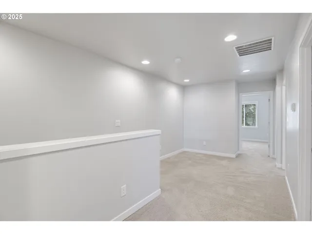 a view of an empty room and a bathroom