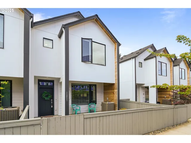 a view of an house with backyard and balcony