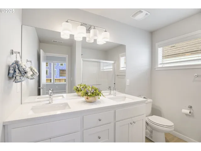 a bathroom with a glass shower door
