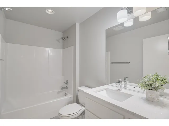 a bathroom with a sink vanity and mirror