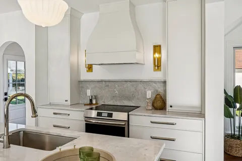 a kitchen with a white cabinets and appliances