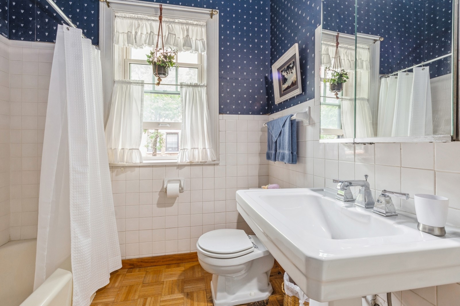 3122 North Sheridan Road, Unit 1B Chicago, IL 60657 - Photo 13 of 16 a bathroom with a sink a toilet and a mirror