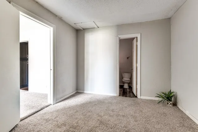 an empty room with closet and a window