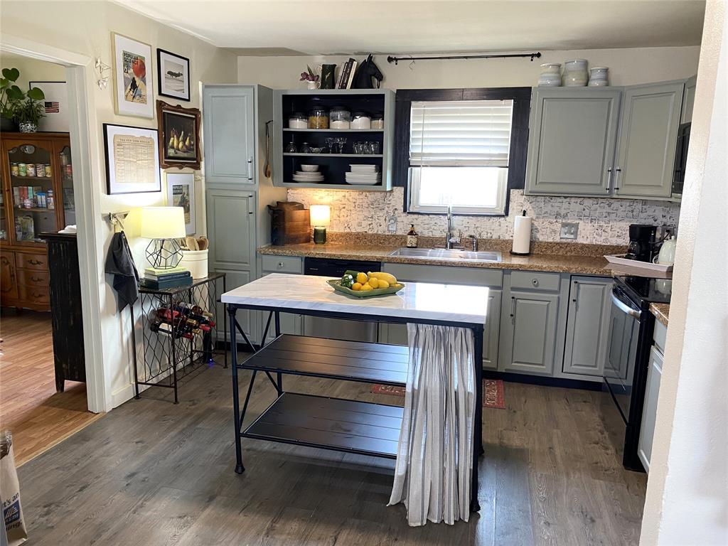 321 School House Road Paradise, TX 76073 - Photo 12 of 18 a kitchen with stainless steel appliances a stove a refrigerator and a cabinets