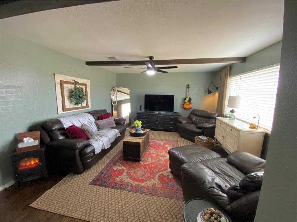 321 School House Road Paradise, TX 76073 - Photo 2 of 18 a living room with furniture and a flat screen tv