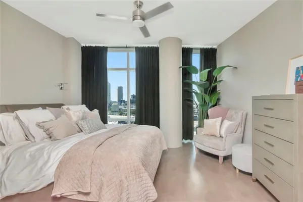 a living room with furniture and a floor to ceiling window