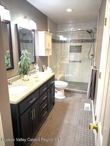 an empty room with wooden floor and closet