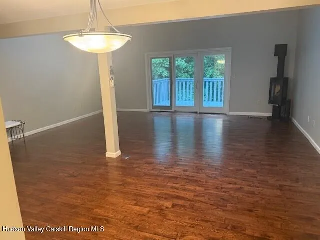 a view of a livingroom with wooden floor and a chandelier