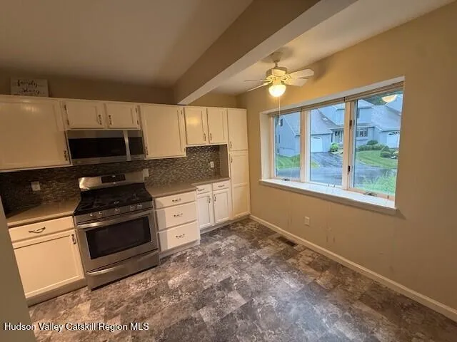 a kitchen with a stove a sink and a microwave
