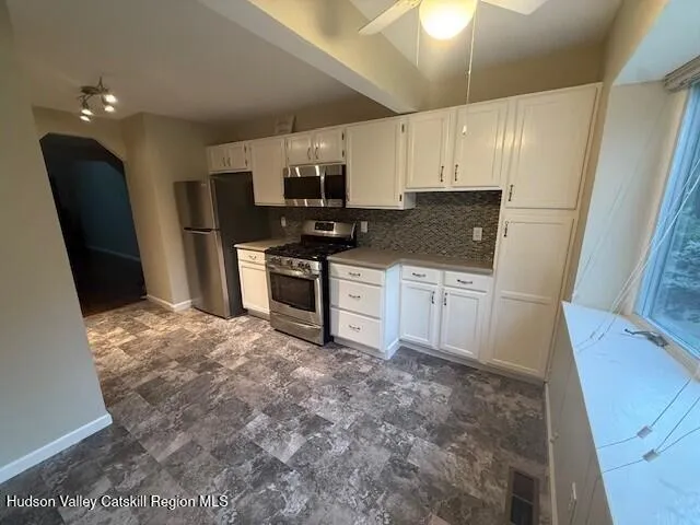 a kitchen with a sink a refrigerator and a stove