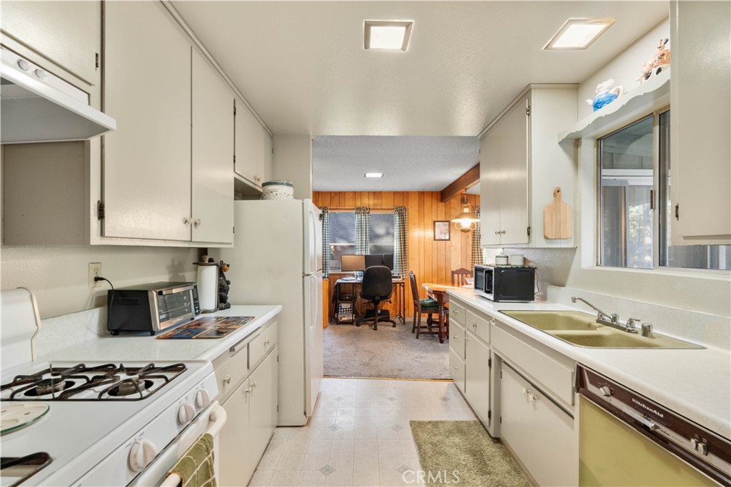 1130 Robin Road Wrightwood, CA 92397 - Photo 14 of 34 a kitchen that has a lot of cabinets in it and wooden floors