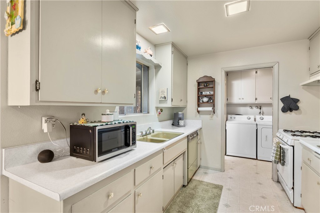 1130 Robin Road Wrightwood, CA 92397 - Photo 15 of 34 a kitchen with a sink stove and cabinets