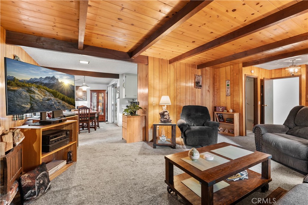 1130 Robin Road Wrightwood, CA 92397 - Photo 2 of 34 a living room with furniture a flat screen tv and kitchen view