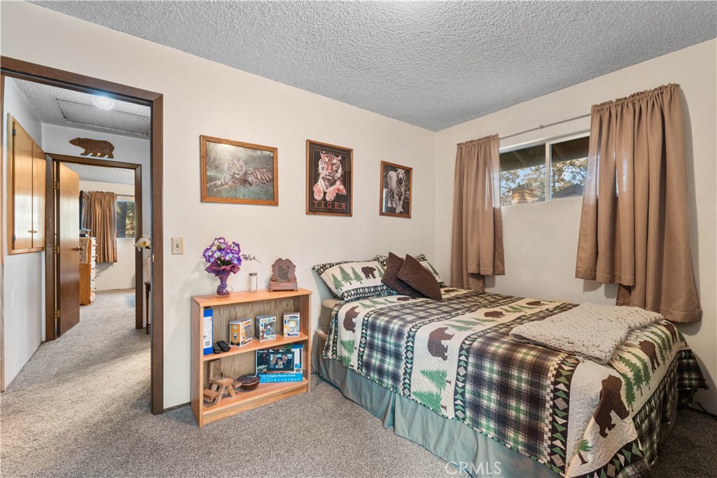 1130 Robin Road Wrightwood, CA 92397 - Photo 23 of 34 a bedroom with a bed and a window