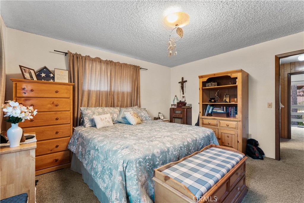 1130 Robin Road Wrightwood, CA 92397 - Photo 25 of 34 a bedroom with a bed and dresser