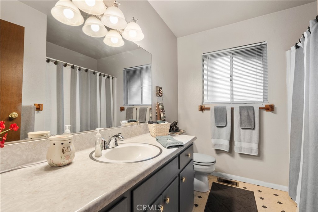 1130 Robin Road Wrightwood, CA 92397 - Photo 28 of 34 a bathroom with a sink double vanity and a mirror