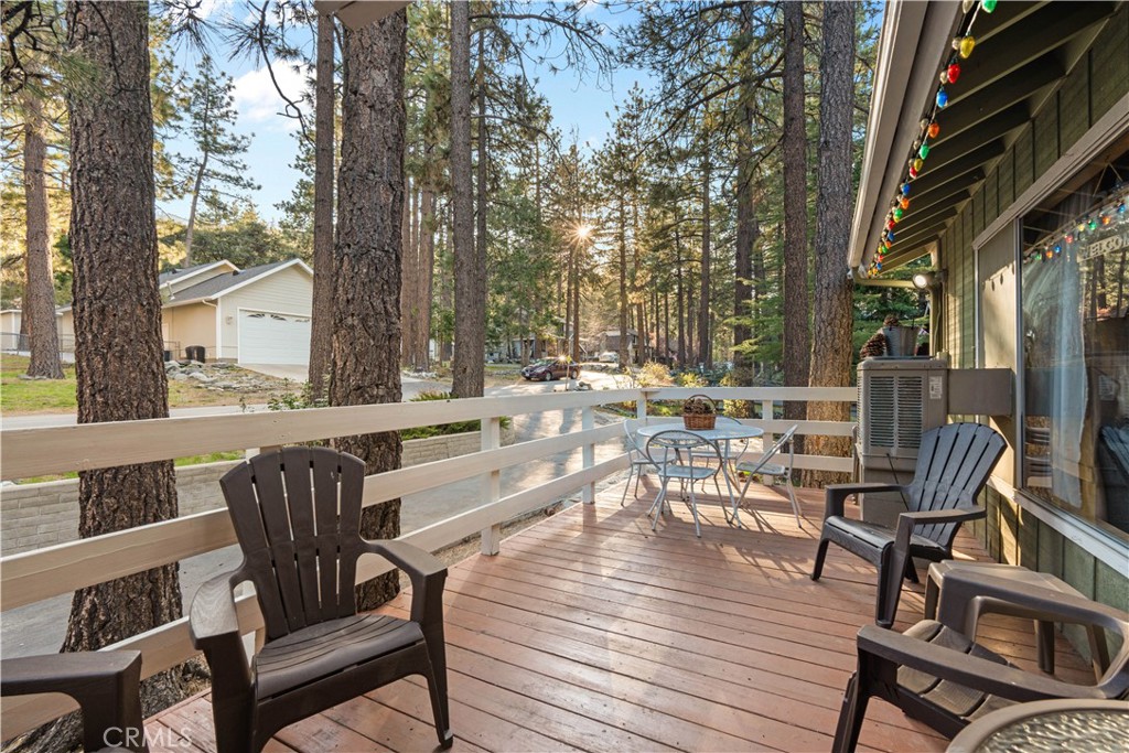 1130 Robin Road Wrightwood, CA 92397 - Photo 8 of 34 a view of a patio with a table chairs and wooden floor