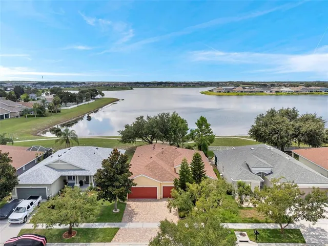 an aerial view of a house with a lake view