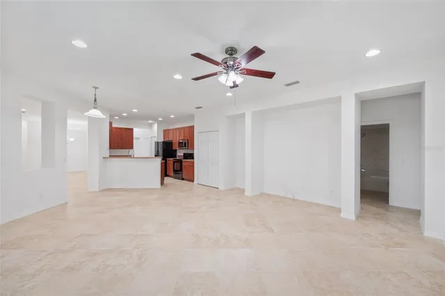 a view of an empty room with a ceiling fan
