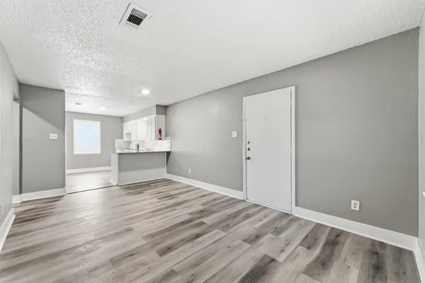 a view of kitchen and hall with wooden floor