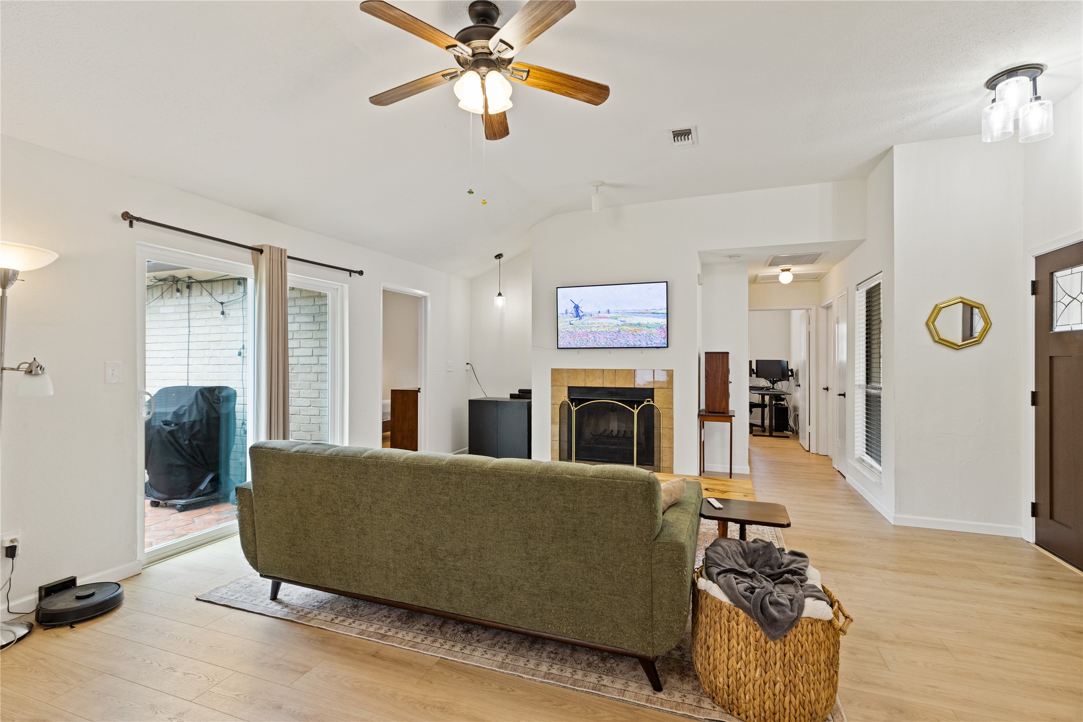 9719 Orangevale Drive Spring, TX 77379 - Photo 7 of 32 Large attractive den highlighted by fireplace and beautiful wood flooring.