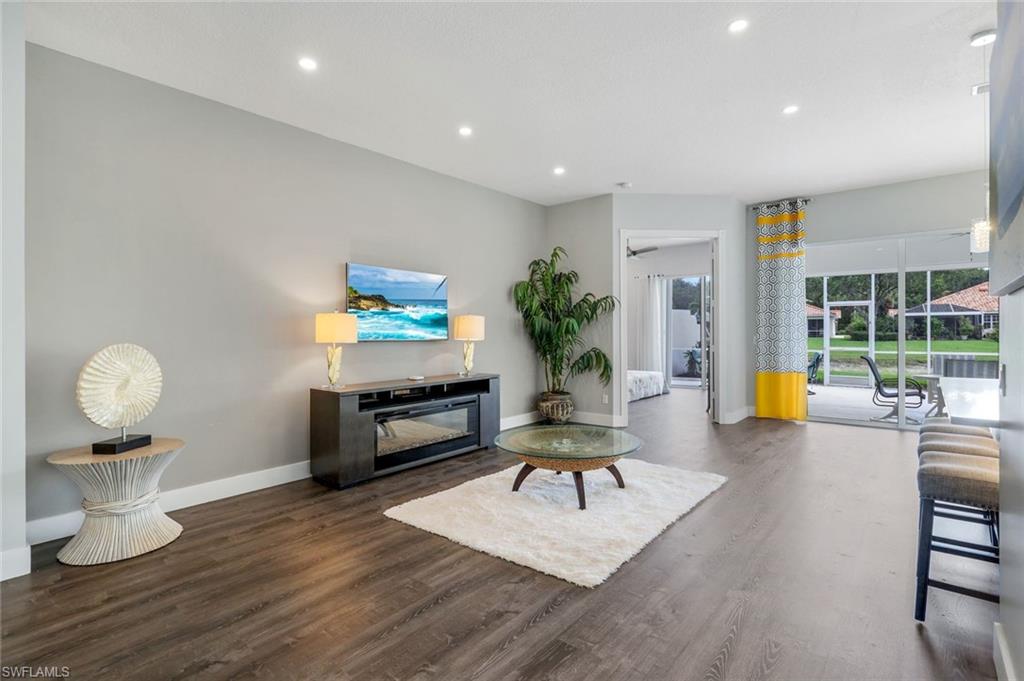 4648 Rio Poco Court Naples, FL 34109 - Photo 9 of 27 Living room with baseboards, finished floors, and recessed lighting