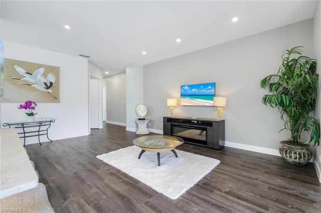 4648 Rio Poco Court Naples, FL 34109 - Photo 10 of 27 Living room featuring finished floors, baseboards, and recessed lighting