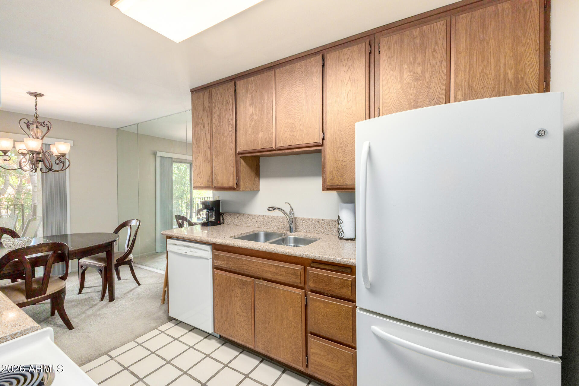 5525 East Thomas Road, Unit H7 Phoenix, AZ 85018 - Photo 11 of 27 a kitchen with a sink a stove and chairs