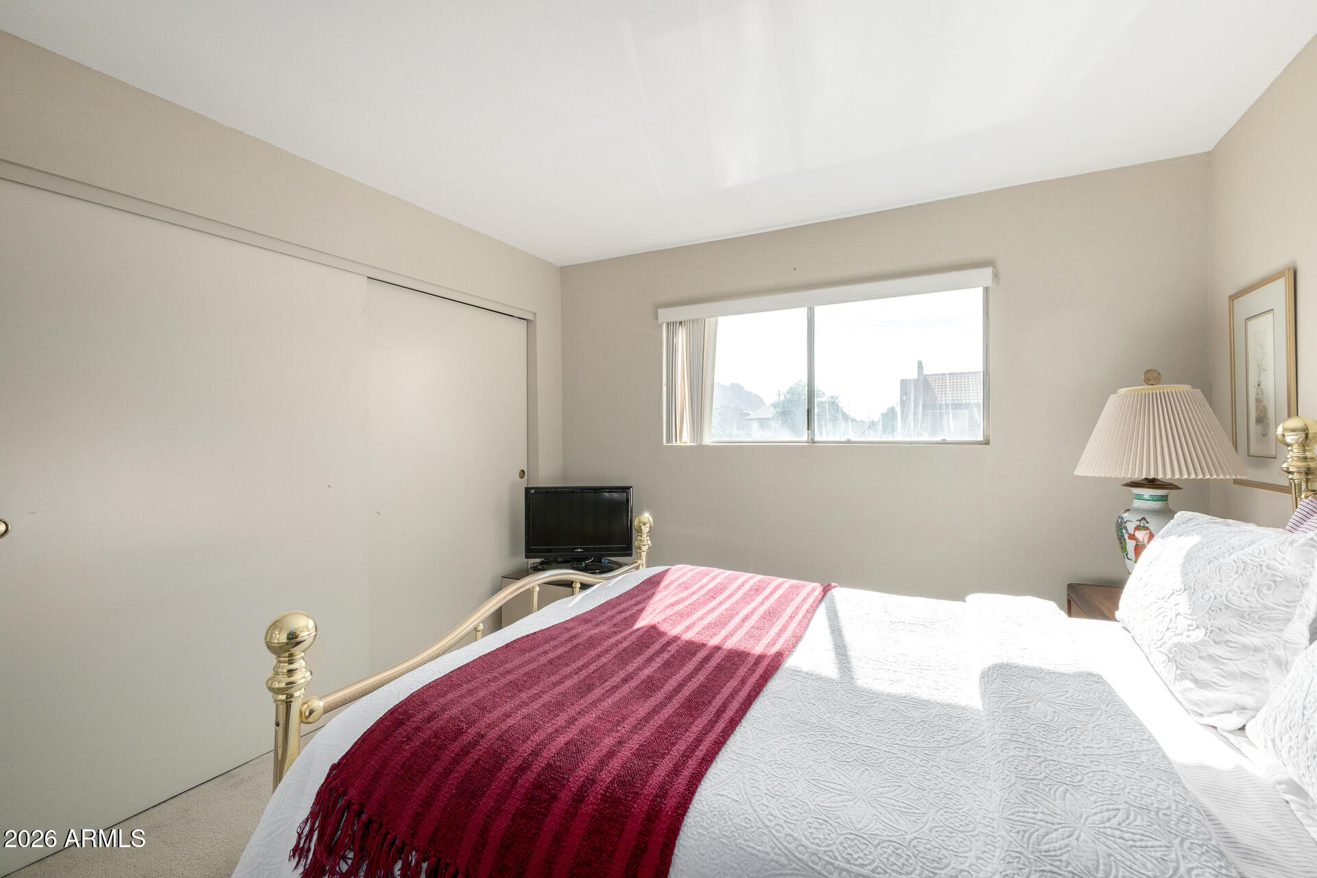 5525 East Thomas Road, Unit H7 Phoenix, AZ 85018 - Photo 13 of 27 a bedroom with a bed and a window