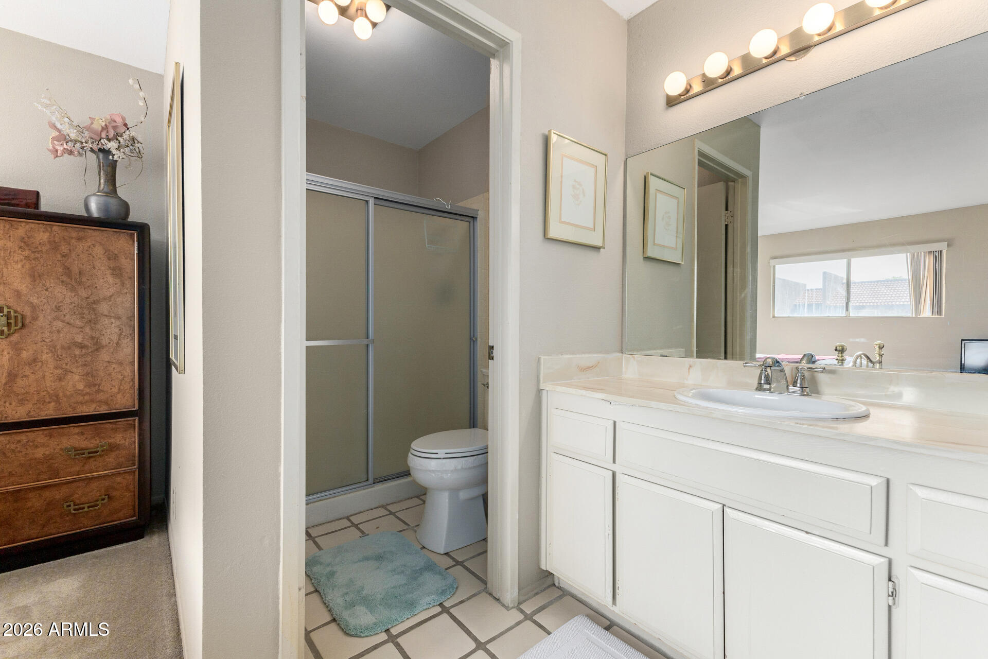 5525 East Thomas Road, Unit H7 Phoenix, AZ 85018 - Photo 15 of 27 a bathroom with a granite countertop sink toilet and mirror