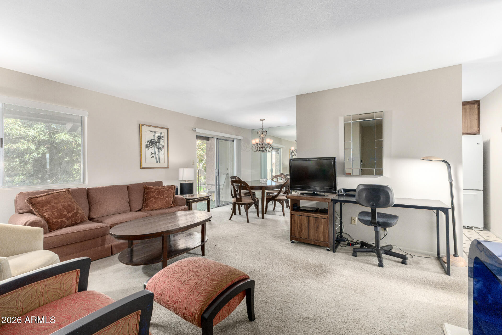 5525 East Thomas Road, Unit H7 Phoenix, AZ 85018 - Photo 4 of 27 a living room with furniture and a flat screen tv