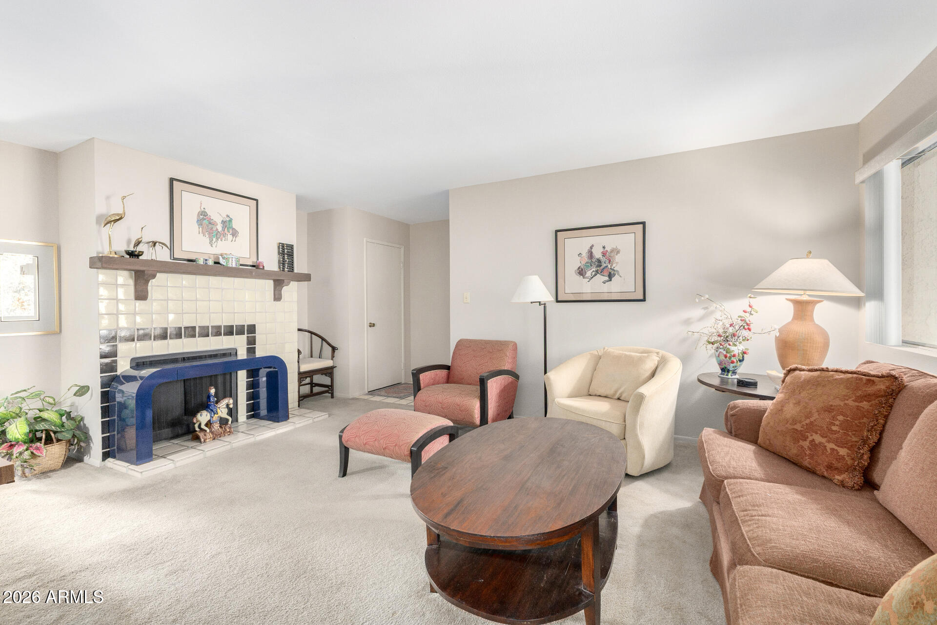 5525 East Thomas Road, Unit H7 Phoenix, AZ 85018 - Photo 6 of 27 a living room with furniture a fireplace and a potted plant