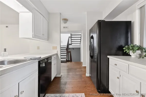 a kitchen with a refrigerator and a sink